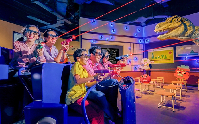 Visitors enjoying a 3D laser shooting game at IMG Worlds of Adventure.