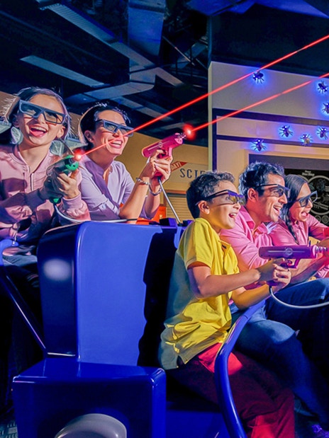 Visitors enjoying a 3D laser shooting game at IMG Worlds of Adventure.