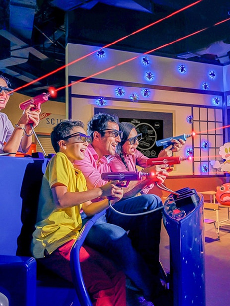 Visitors enjoying a 3D laser shooting game at IMG Worlds of Adventure.