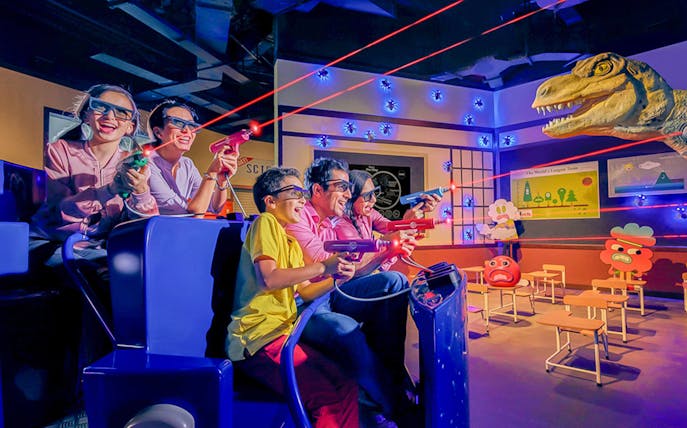 Visitors enjoying a 3D laser shooting game at IMG Worlds of Adventure.