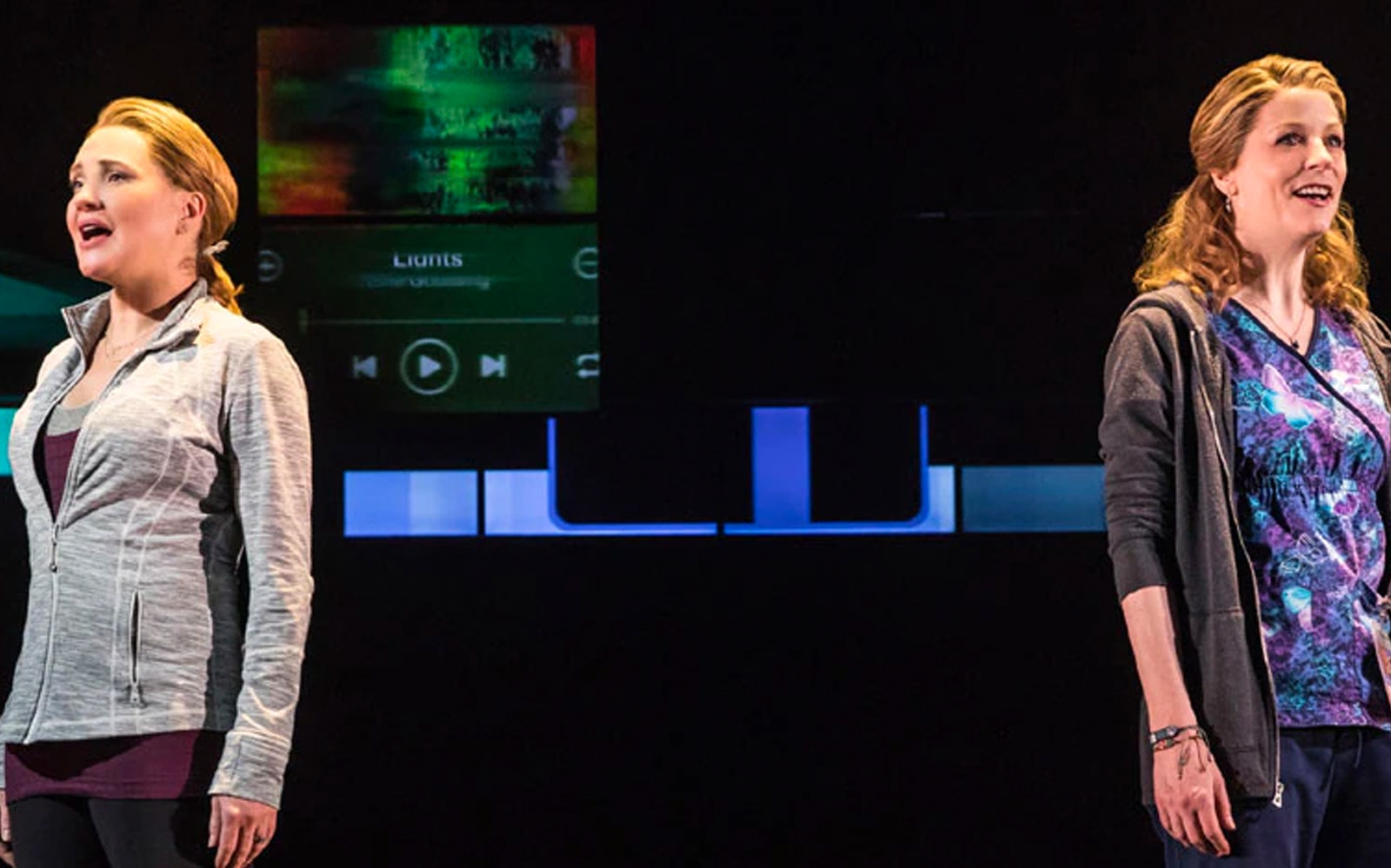 Two performers singing on stage during a scene from Dear Evan Hansen.