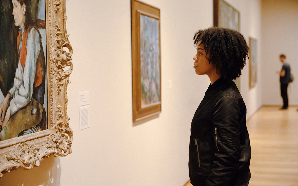 Visitor observing artwork at the Museum of Modern Art, New York.