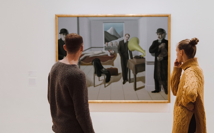 Visitors viewing a painting at the Museum of Modern Art, New York.