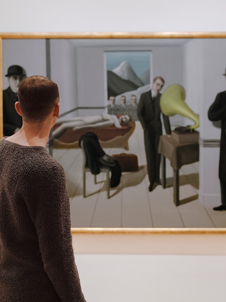 Visitors viewing a painting at the Museum of Modern Art, New York.