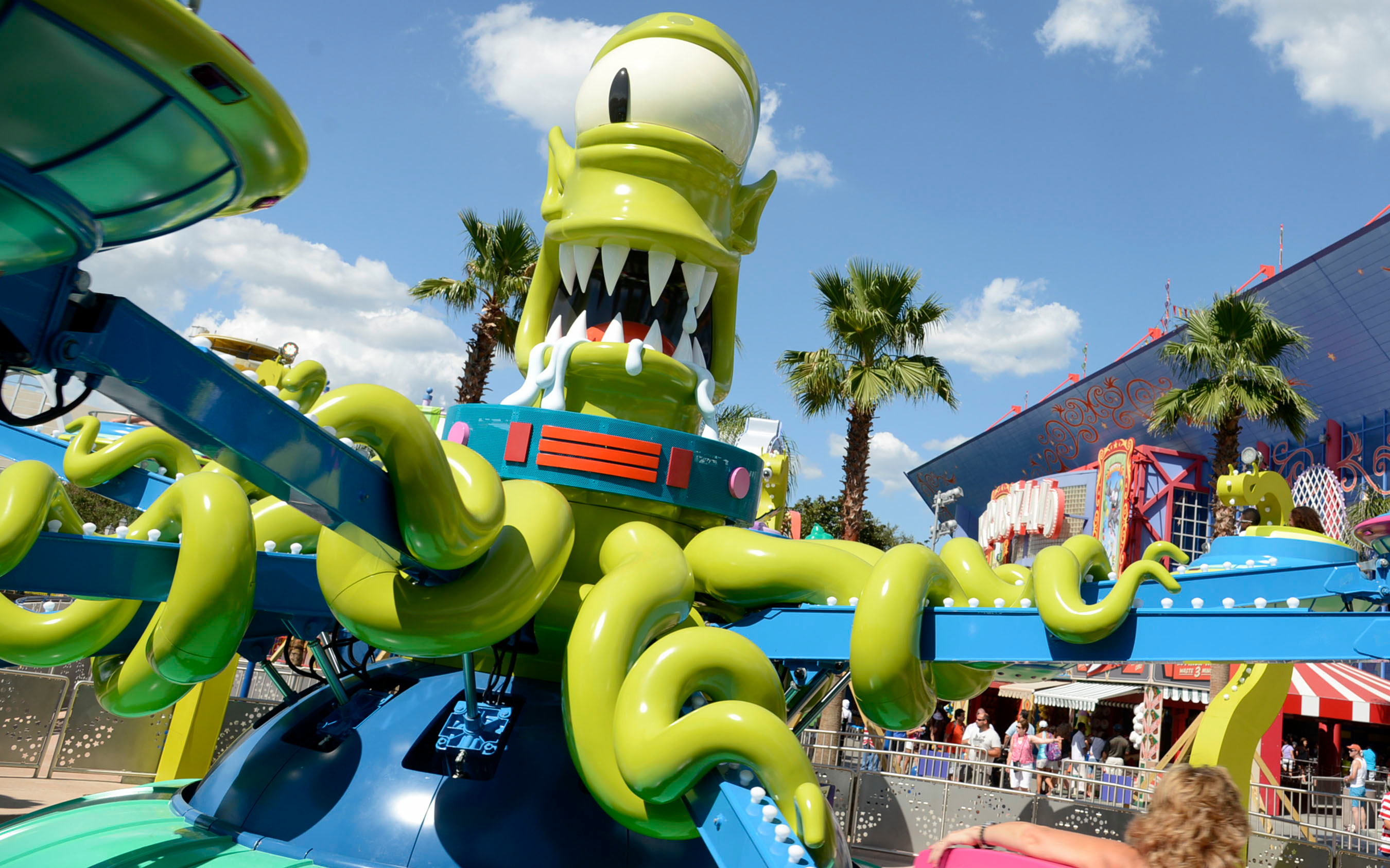 Alien-themed ride at Universal Orlando Resort with green tentacles and colorful backdrop.