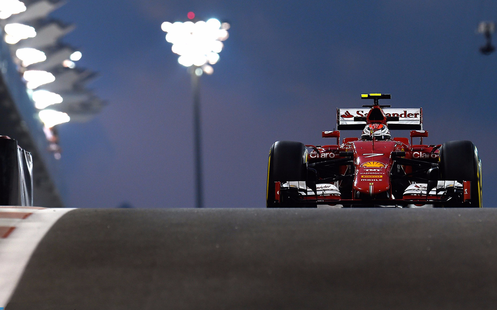 Formula 1 car racing at Abu Dhabi Grand Prix 2017 under lights.
