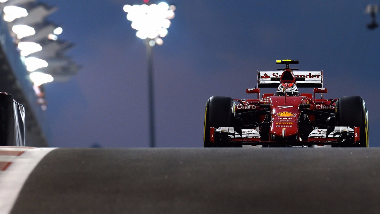 Formula 1 car racing at Abu Dhabi Grand Prix 2017 under lights.