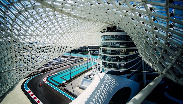 Yas Marina Circuit track view during Abu Dhabi Grand Prix, featuring modern architecture.