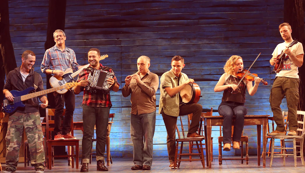 Musicians performing on stage in the musical "Come From Away.