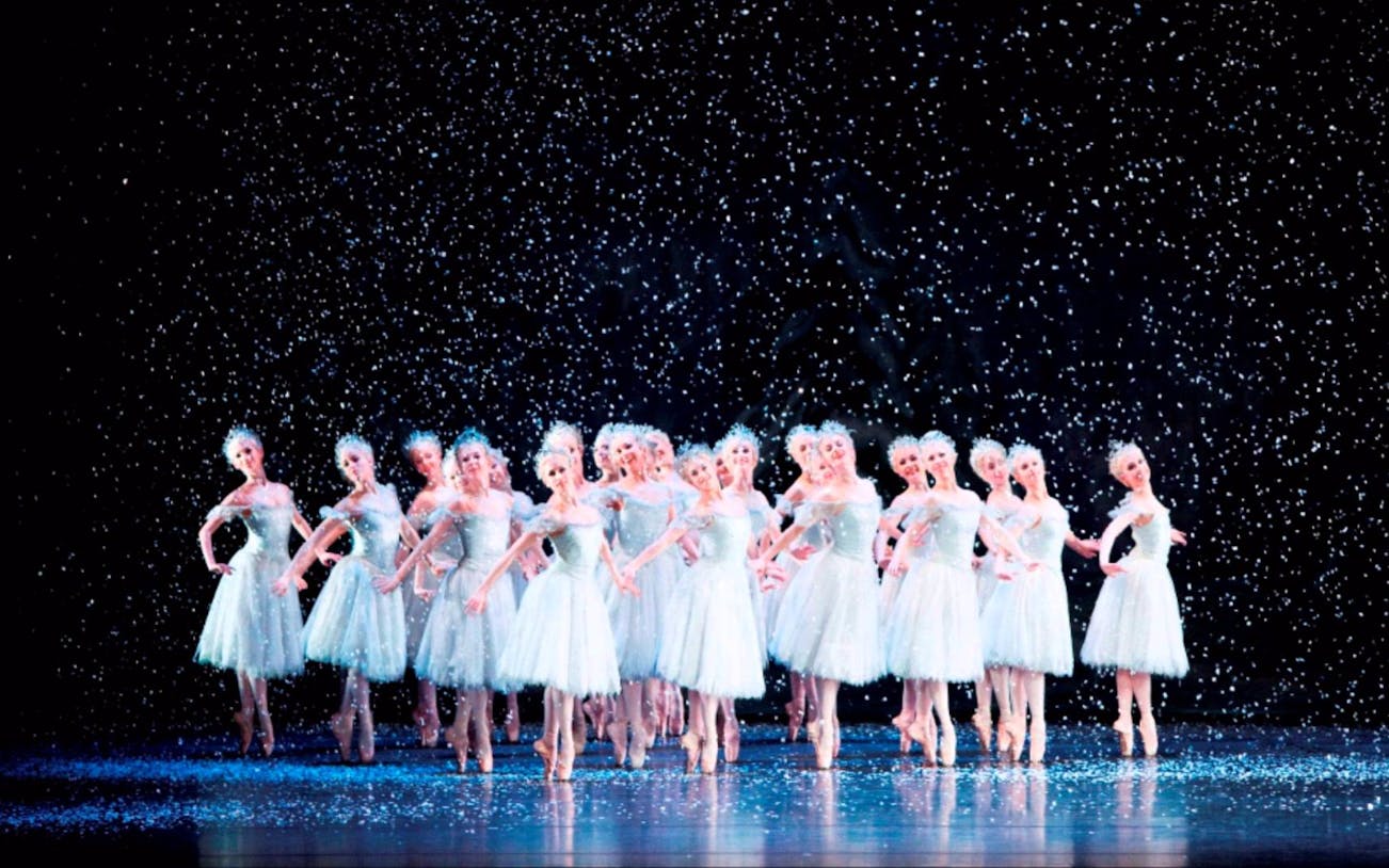 Ballet dancers performing in snow scene from The Nutcracker at the Royal Opera House.