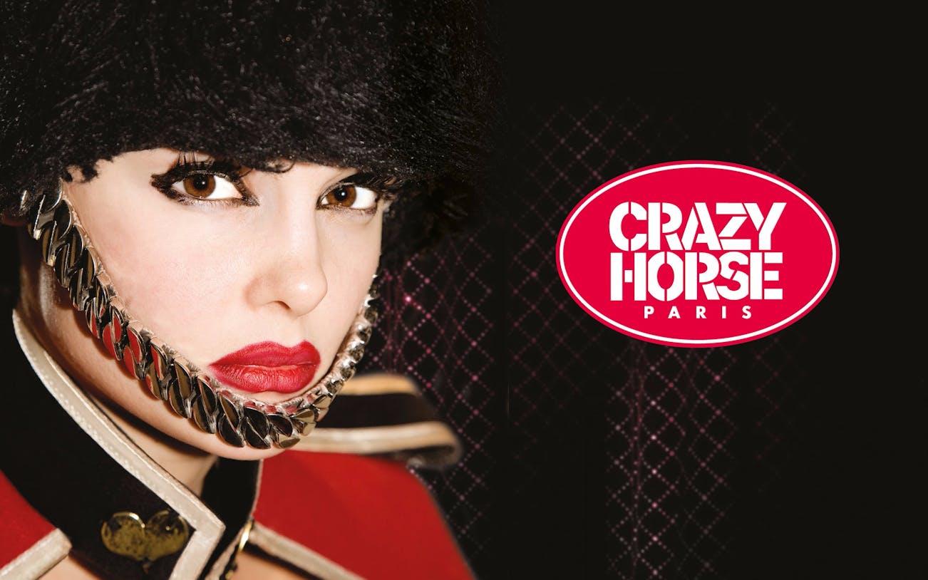 Performer in costume at Crazy Horse Paris with logo.