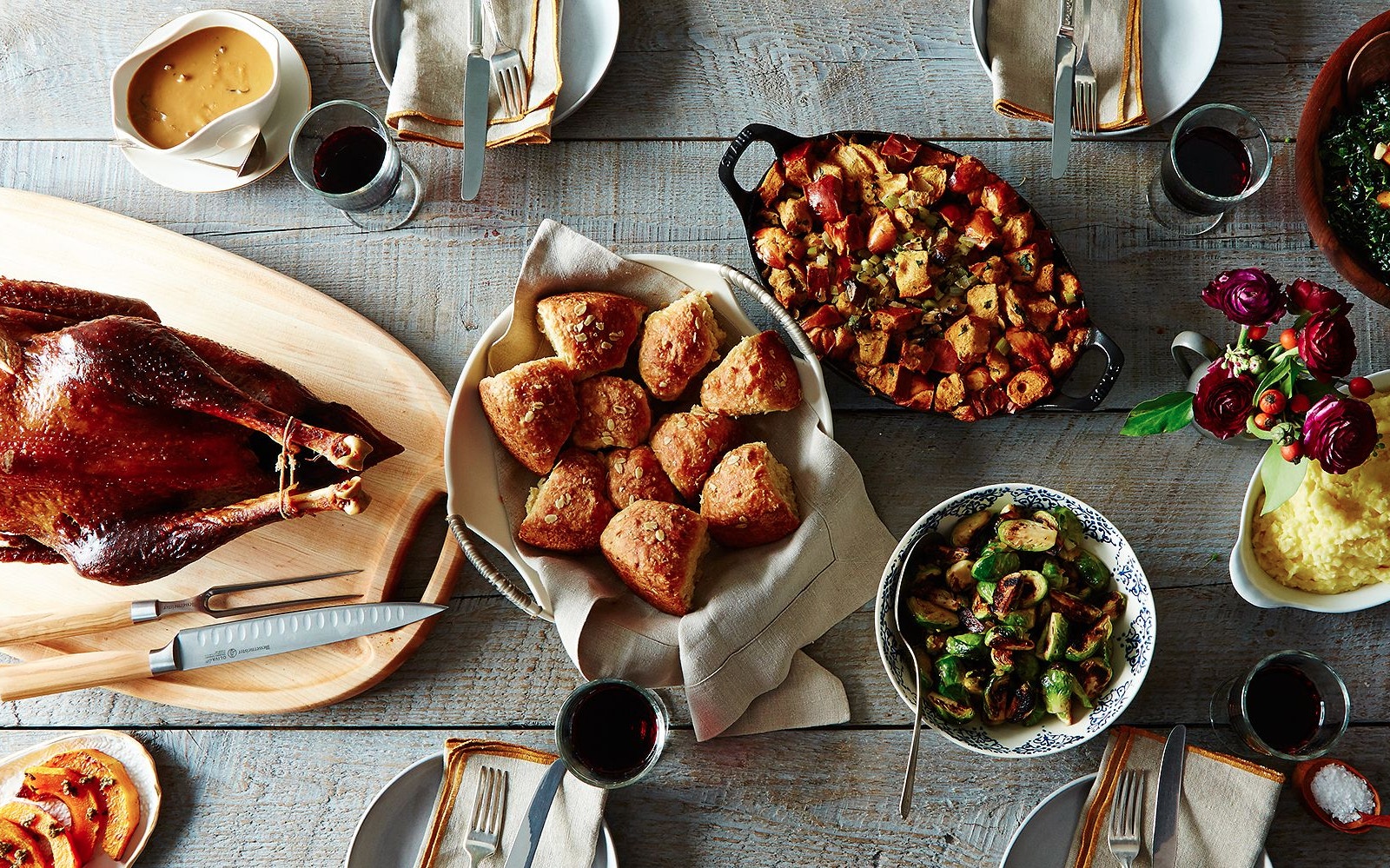 Thanksgiving dinner spread with turkey, stuffing, rolls, and sides in New York City.