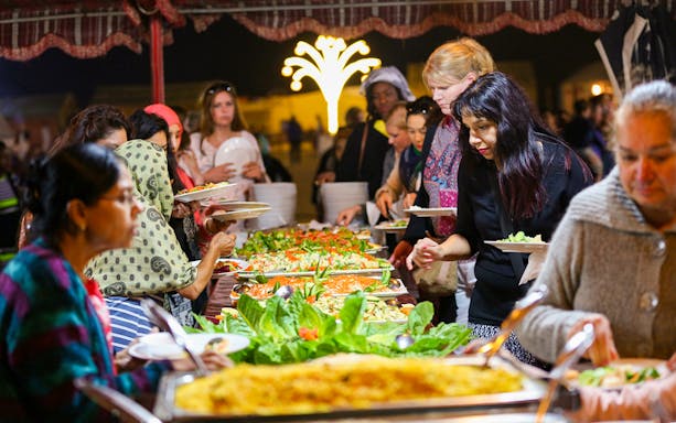 Guests enjoying a buffet dinner during a desert safari experience.
