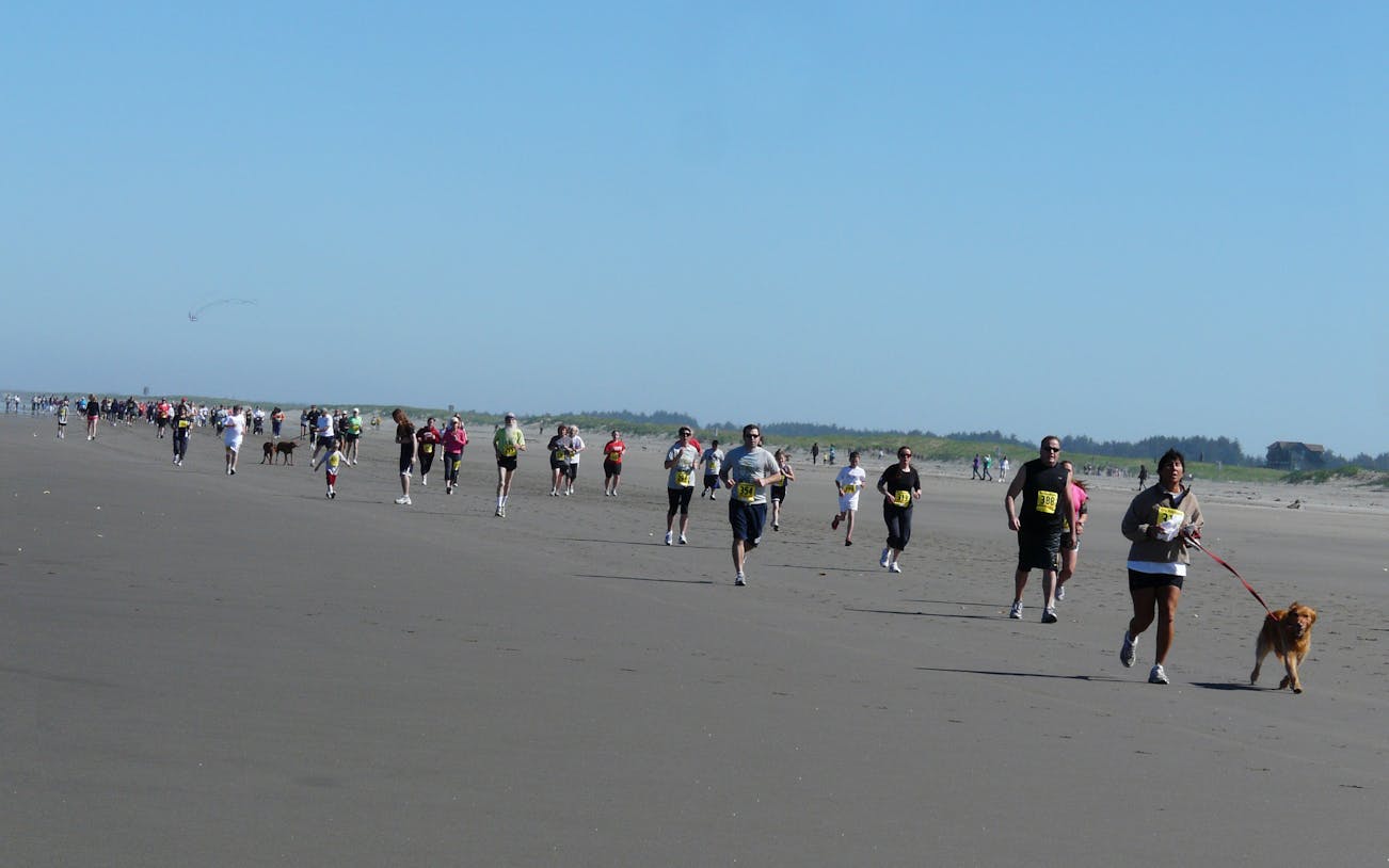 Participants running on a beach during The Unity Run Dubai 2016.