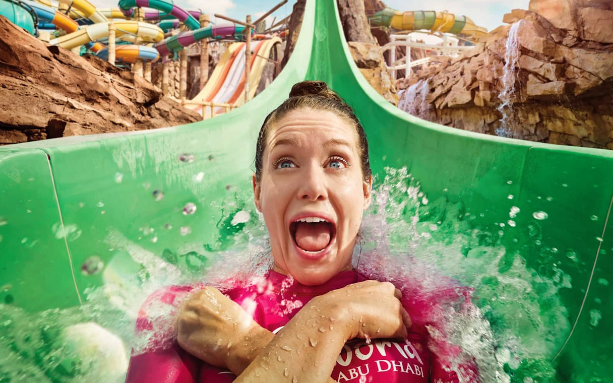 Person enjoying a water slide at Yas Waterworld, Abu Dhabi.