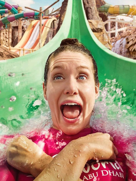 Person enjoying a water slide at Yas Waterworld, Abu Dhabi.