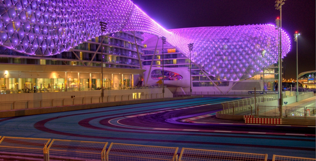 Yas Marina Circuit at night, Abu Dhabi, with illuminated hotel and racetrack.
