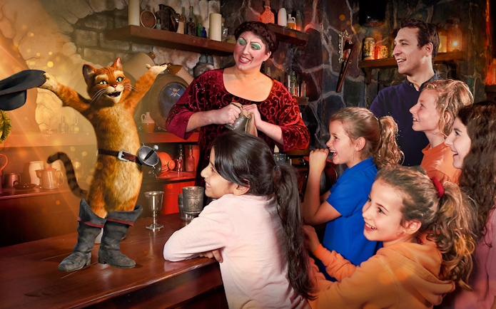 Children enjoying a live Puss in Boots performance at Shrek's Adventure London.