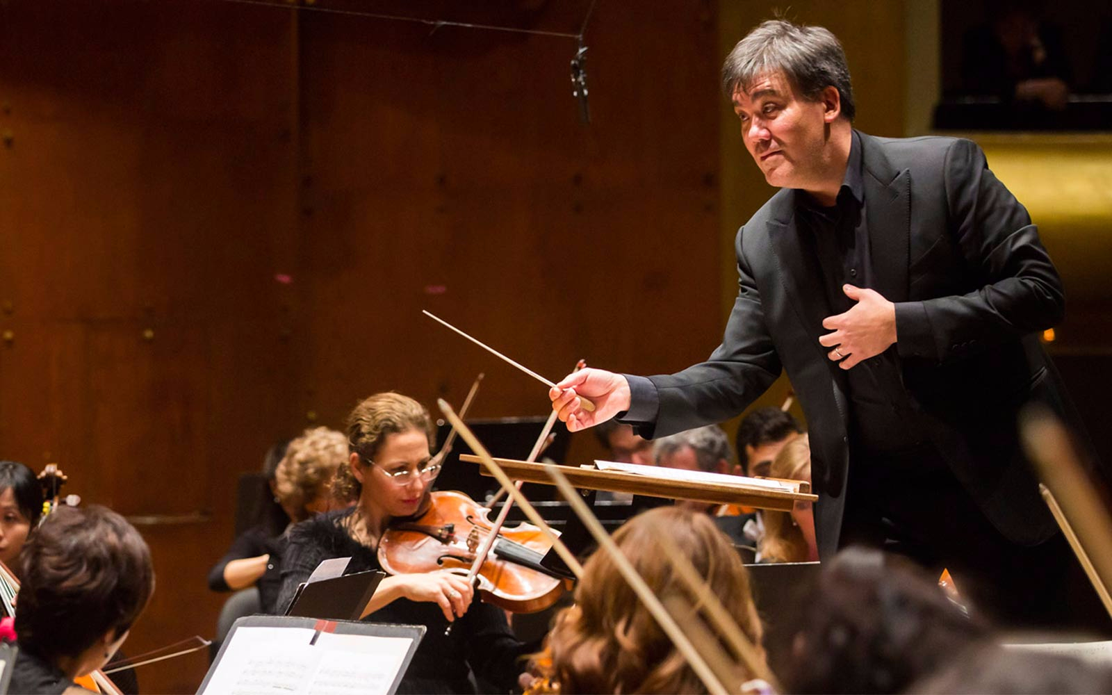 Conductor leading the Baltic Philharmonic orchestra during a performance.