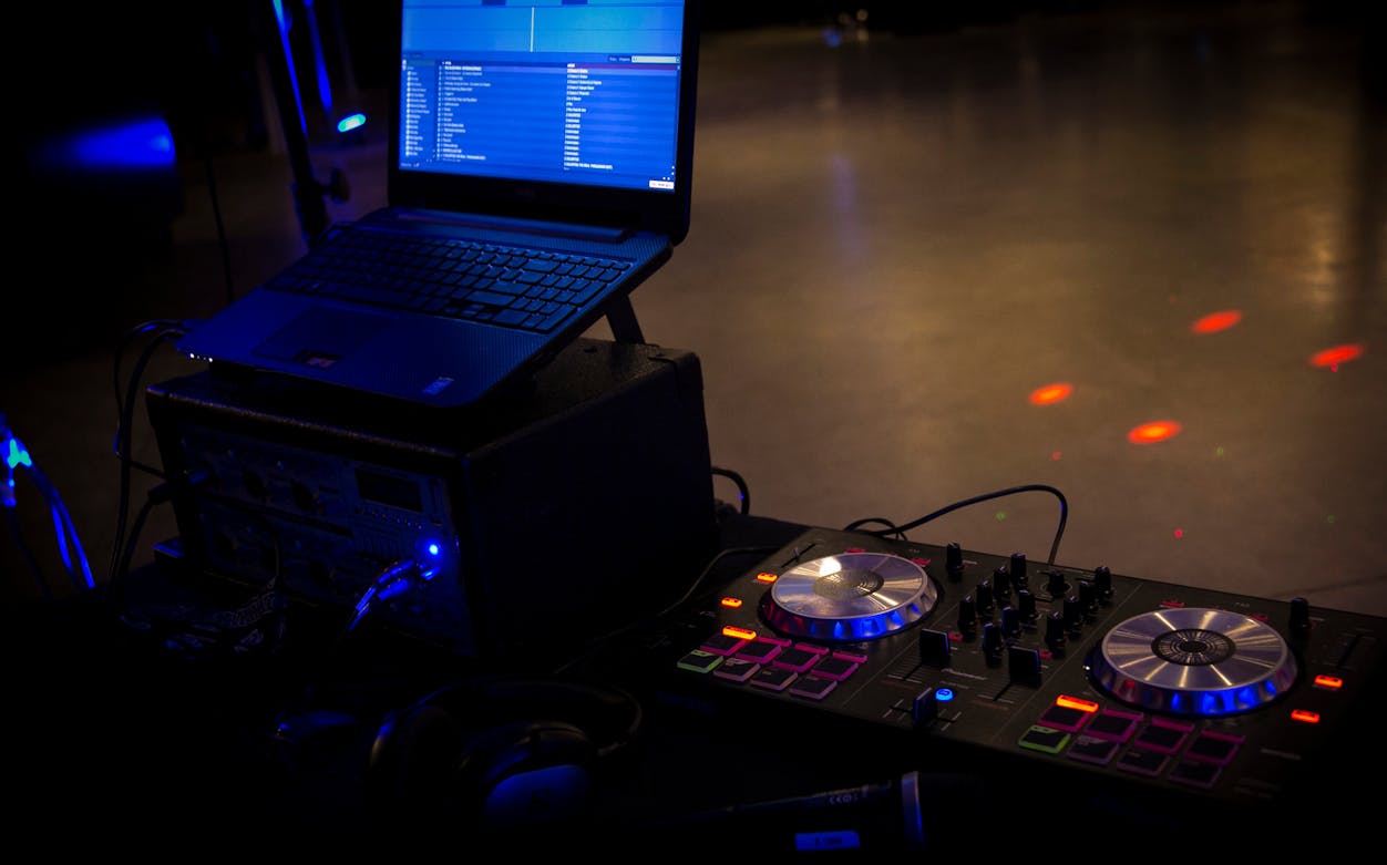 DJ setup with laptop and mixer at Prohibition Brunch Party.