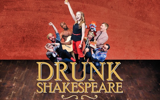 Actors performing Drunk Shakespeare with props and costumes on stage.