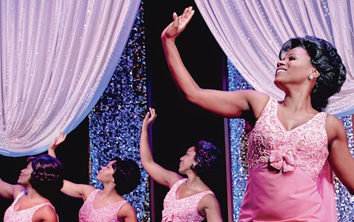 Performers in pink dresses on stage during Beautiful: The Carole King Musical.