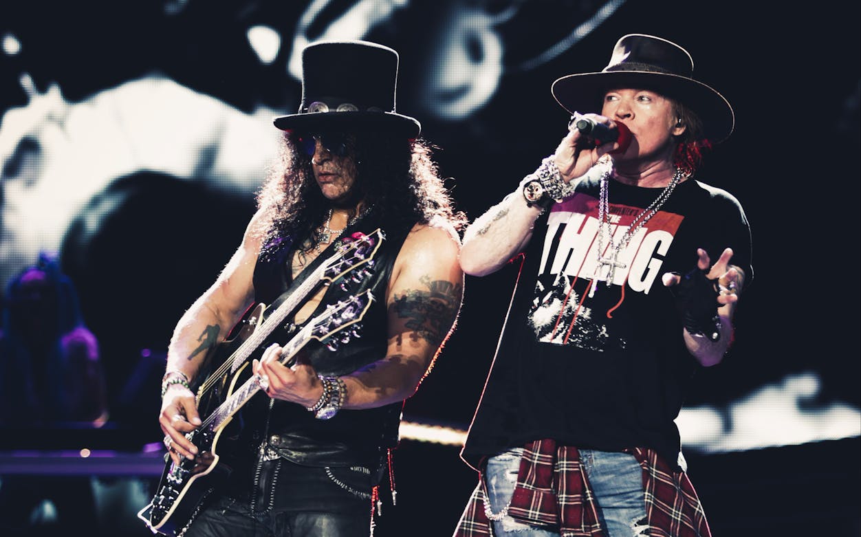 Guitarist and singer performing at Guns N' Roses concert in Dubai.