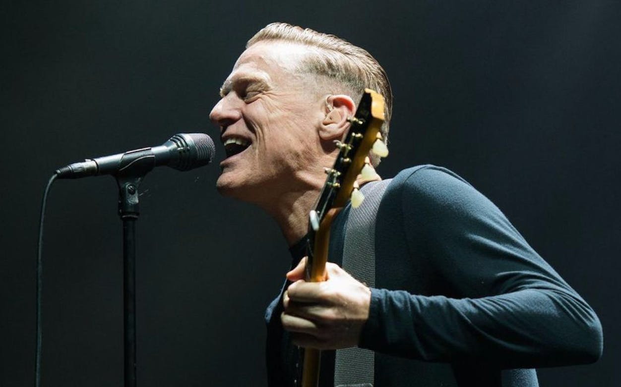 Bryan Adams performing live on stage during his World Tour.