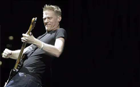 Guitarist performing on stage during Bryan Adams World Tour.