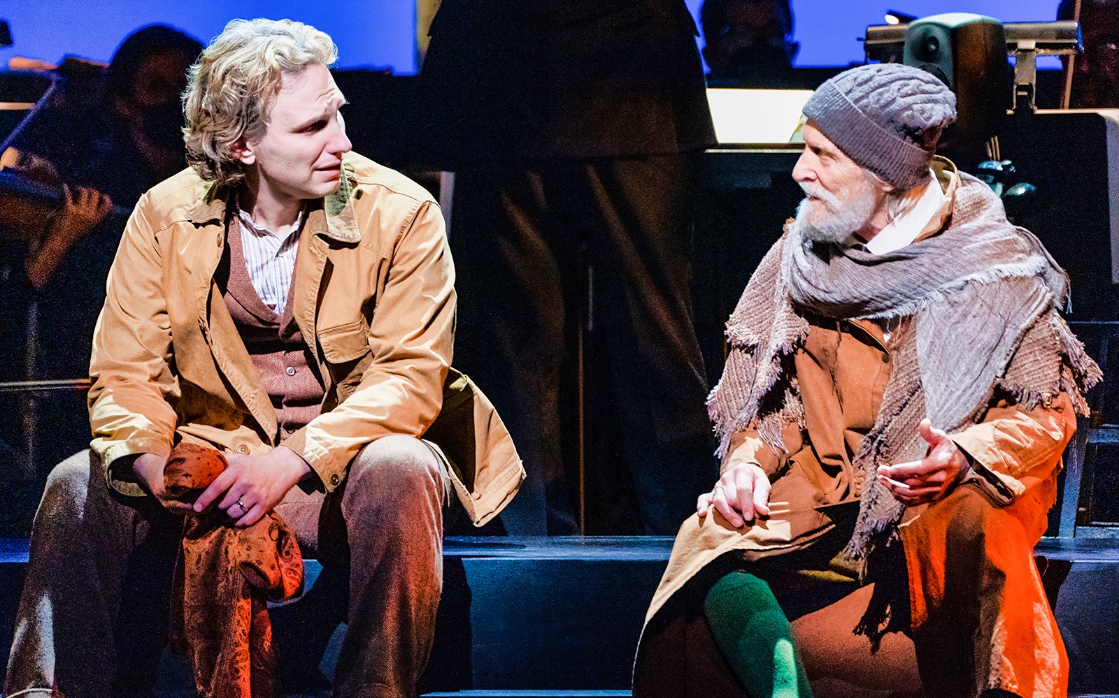 Two actors in costume performing a scene from "Into The Woods" on stage.