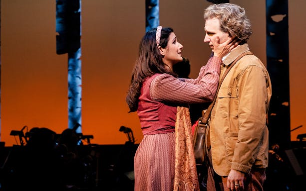 Two actors in a dramatic scene on stage during "Into The Woods" performance.