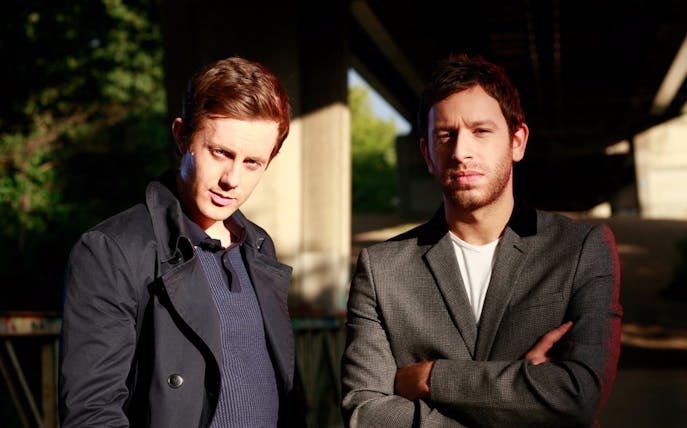 Two DJs posing outdoors for Zero Gravity New Year's Eve Party event.