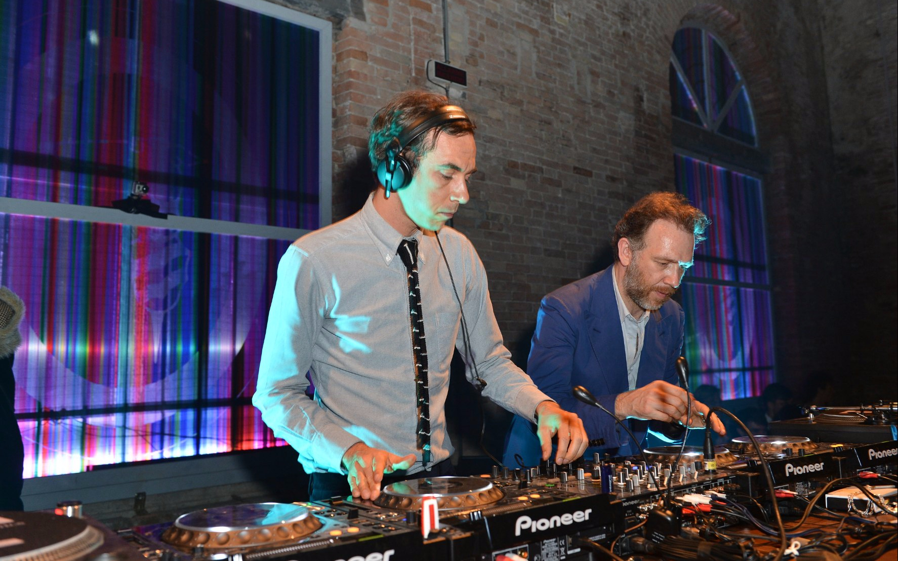 DJs performing at Zero Gravity New Year's Eve Party with colorful lights in the background.